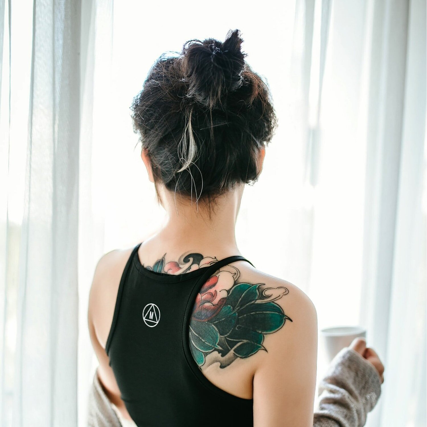 A person looking out through a bright window